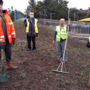 David Dowding, wildlife ranger for Ipswich Borough Council’s wildlife ranger team, and Derby Road station adopter's Dennis Carpenter, Claire Kendal and Tom prepare the pollinator patch