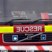Fire crews have put out a fire that spread to three gardens because of some hot embers