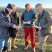 James Cartlidge, right, with local residents on the route of the proposed power lines.