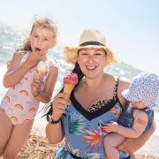 Temperatures are expected to soar this weekend, but experts say that it is unlikely they will exceed 40C. Pictured: Abigail, Gabi and Archie Chapman enjoying an ice cream.