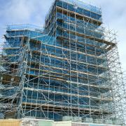 Orford Castle is shrouded in scaffolding as preservation work takes place - but you can scale the building's exterior this summer