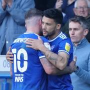 Macauley Bonne and James Norwood embrace, as the pair swap places with Bonne coming on as a second half substitute.
