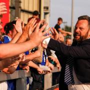 Ipswich Town CEO Mark Ashton celebrates with fans after the Blues' first win of the season at Lincoln City yesterday