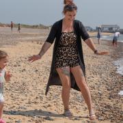 Gemma Sharp and Primrose Taylor Mockett enjoying the sunshine on the beach in Walberswick.