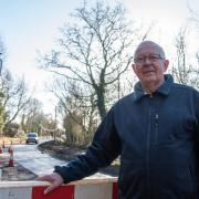 Otley parish councillor Martin Hunt next to the temporary traffic lights, which plagued residents for more than a year in 2022.