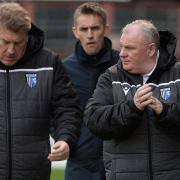 Gillingham assistant Paul Raynor and boss Steve Evans walk to the dug-outs before the match with Ipswich Town yesterday. The Blues won 4-0