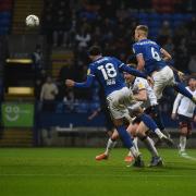 Luke Woolfenden attacks a corner at Bolton