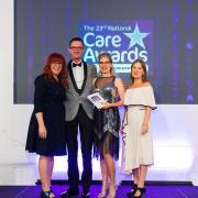 Geoff Edwards and Elena Bratu of Care UK receiving Davers Court's Care Home of the Year award at the National Care Awards