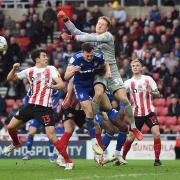 George Edmundson collides with Thorben Hoffman during the first half at The Stadium of Light against Sunderland