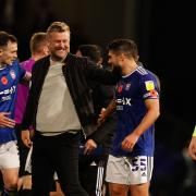 Ipswich Town players George Edmundson (left) and Sam Morsy (right) have a word with Oxford United manager Karl Robinson at the final whistle.