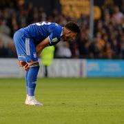 Macauley Bonne vents his frustration on the final whistle at Cambridge.