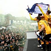 Cambridge United celebrate with their fans after winning promotion to League One last season.