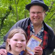 David Howden with his daughter Katelyn on the bridge at East Town Park, in Haverhill, which is illustrated in Mr Howden's latest book.