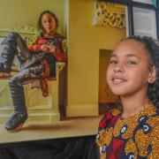 A'naih Marie with her picture, taken by John Ferguson, at the Black Suffolk exhibition at Ipswich Cornhill.