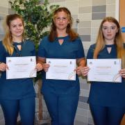 Students Tia Copland, Molly Hooper and Rhiannon Lamb with their certificates after training at Suffolk New College in how to spot signs of domestic abuse