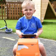 Cian at Claydon Pre-school, which now has a new play area.