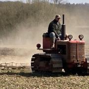 Russel Abbott on his tractor in his field near Ipswich.