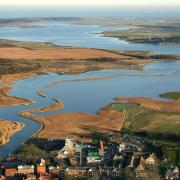 Community leaders have called for the Environment Agency's investigation into the flood defence work on the Alde and Ore Estuary to be concluded quickly.