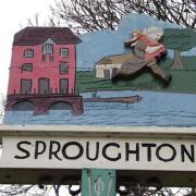 The village Sproughton village sign shows the wild man who was said to live in nearby Devil's Wood.