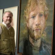 Artist Colin Davidson next to his portraits of Ed Sheeran  Picture: SARAH LUCY BROWN