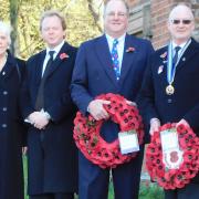 Taking the salute at Melford Hall gates, left to right: Audrey Wreford, chairman of Long Melford RBL, Sir Tim Bridge Deputy Lord Lieutenant of Suffolk, William Hyde Parker, of Melford Hall, and councillor John Nunn president of Long Melford RBL Picture: