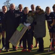 The Ipswich hockey squad with a pre-match presentation to long-serving manager Donna Mills befire their 3-0 win over Old Loughtonians. Picture: IHC