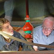Martin Dennison and Tiger Krykant checking the installation of the leather muffle on the tenor bell which weighs over half a ton and is 404 years old. Half muffled bells are traditionally rung at funerals.