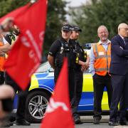 Hutchison Ports Chief Executive Officer Clemence Cheng with police officers watching members of the Unite union man a picket line at one of the entrances to the Port of Felixstowe in August.