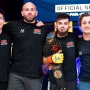 Charlie Falco with his BKK Fighters team after defending his straw-weight title at Cage Warriors Academy South East 29 in Colchester