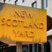 The sign outside New Scotland Yard in London after it was spray painted by a Just Stop Oil protester