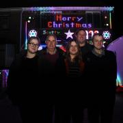The Scott family in front of the Christmas light display