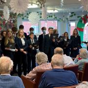 Sybil Andrews Academy brought some festive cheer to Glastonbury Court care home by performing a series of Christmas songs.