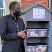Reverend Saul Tadzaushe with the free food pantry that has been set up in Framlingham outside the United Free Church