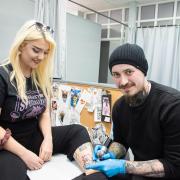 William Langford (right) is tattooing 151 Pokémon characters on people, and giving all profits to charity