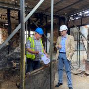 Dr Dan Poulter, right, visited the pub to see how work was progressing last summer.