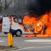 Road closed as van engulfed in flames