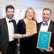 From left: Tom Burdett of LOCALiQ Eastern Counties, who presented the award, with Hannah and Ian Deane of Dairy Barns