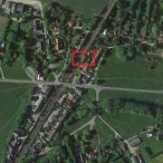 The plans would see the three-storey homes built in a vacant patch of land lying to the north of The Railway Tavern in Mellis. Credit: Google Maps