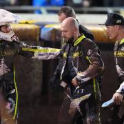 Emil Sayfutdinov checks on Danny King after his fall in heat 10 as he walks back to the pits with Jason Doyle.
