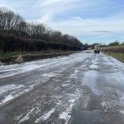 Half of the A143 in Bury St Edmunds is covered in ice while floodwater has been removed