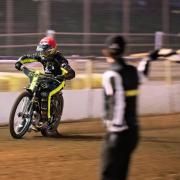 Ipswich Witches skipper Danny King takes the flag to win heat three