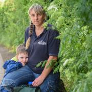 Parish Councillor Gemma Marriage (pictured with her son, Stanley) said that the overgrown pathway is posing a danger to Bucklesham schoolchildren. Image: Charlotte Bond