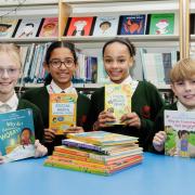 Pupils Millie, Seren, Isobel and Miller with some of the books donated by Barratt and David Wilson Homes  to St Margarets Primary School, Ipswich, for Children’s Mental Health Week.