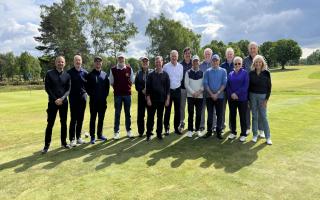 Russell Osman, white shirt centre, and Terry Butcher, second right at the back, among players who re-launched the Forest course at Woodbridge recently.