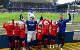 Red Oak Primary School pupils with Mr Lee and Bluey parading the trophy at Portman Road at half time.