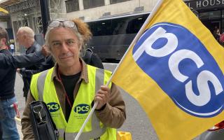 A Public and Commercial Services Union protestor outside the HQ of the Department for Work and Pensions in London.